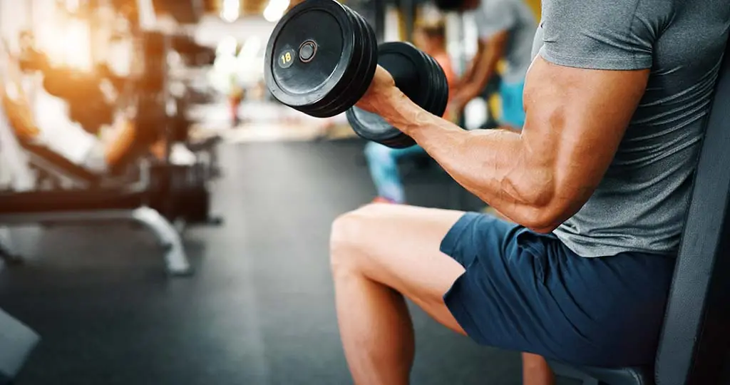 man lifting weights at gym